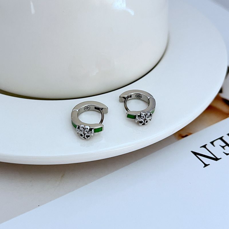 Geometric hoop earrings in silver with green enamel accents, circular hoop detail