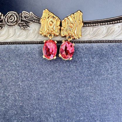 Gold-tone crystal drop earrings with oval red stones