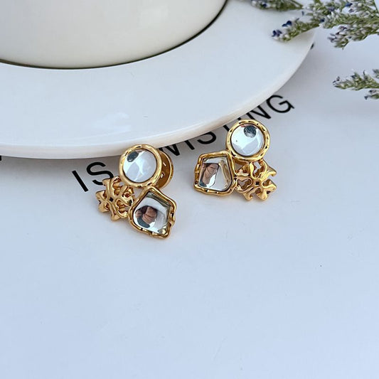 Gold-tone multi-stone stud earrings with light blue and clear square accents