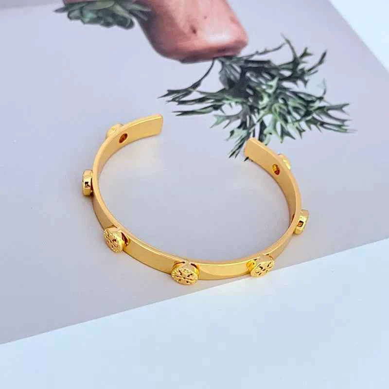 Tory Burch Embossed Metal Open Bangle Gold Color