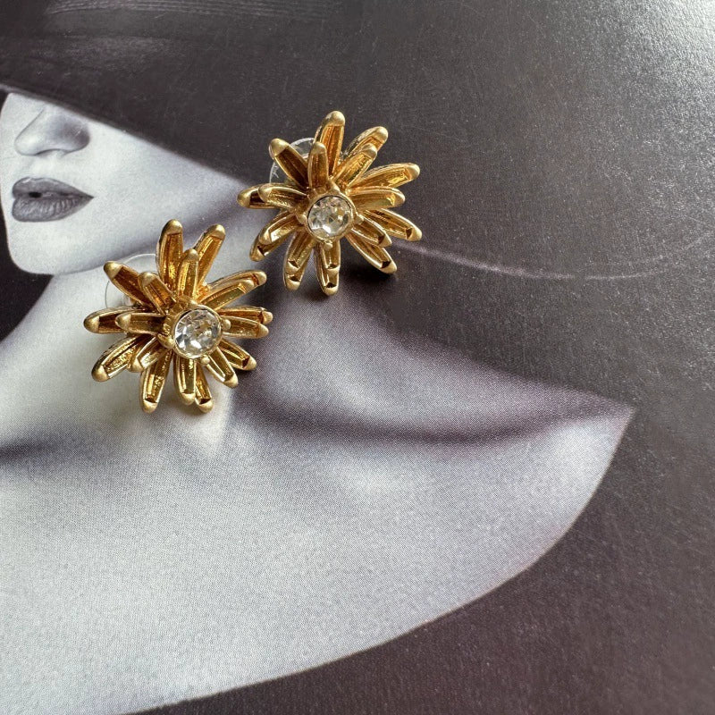 Enamel flower and pineapple diamond earrings with gold flower tops and clear stone centers.