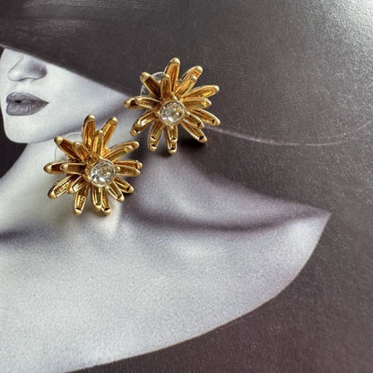 Enamel flower and pineapple diamond earrings with gold flower tops and clear stone centers.
