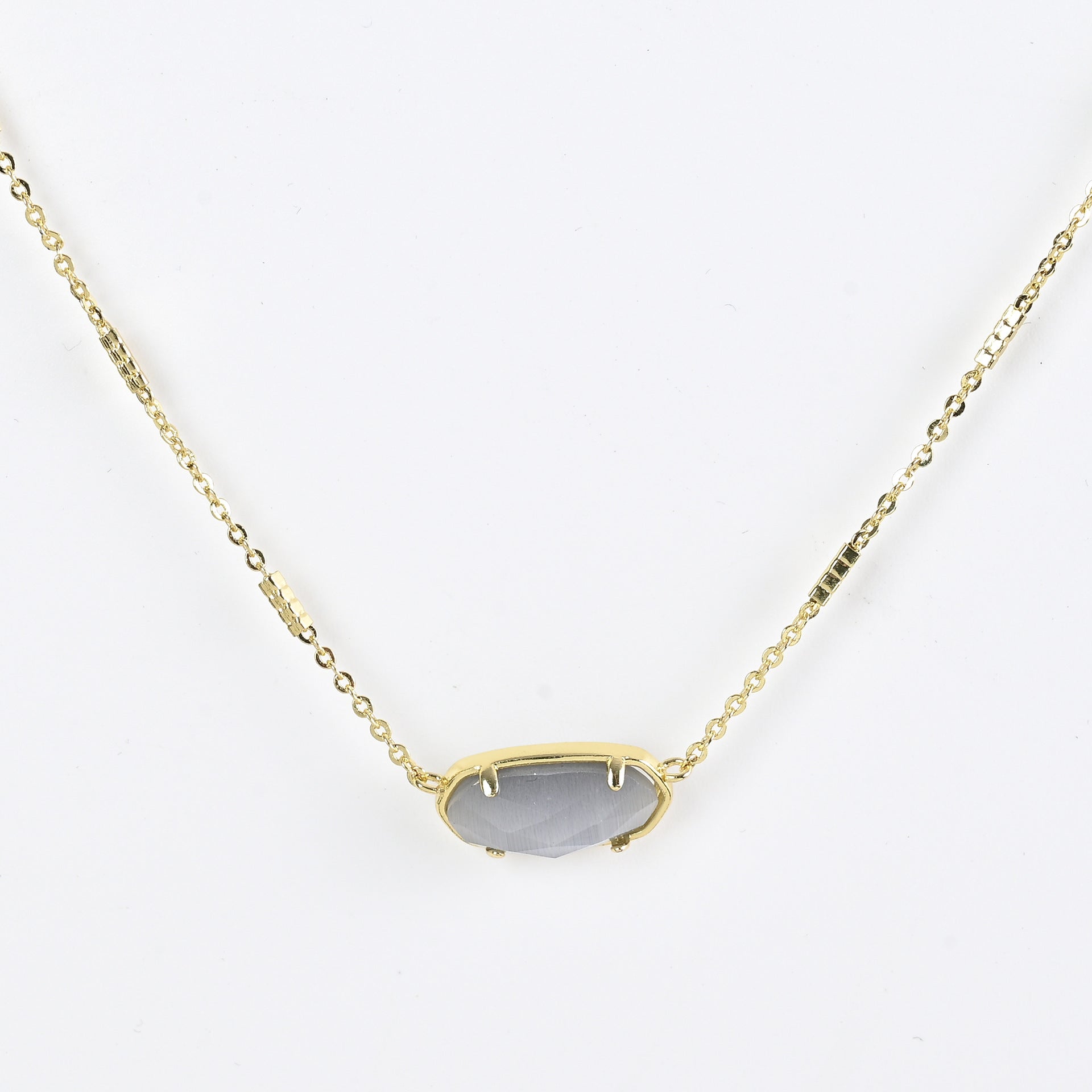 Oval crystal necklace with gold-tone chain and gray oval stone