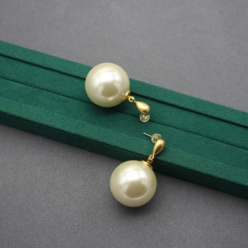 Pair of gold faux-pearl drop earrings with large ivory spheres and loop detail