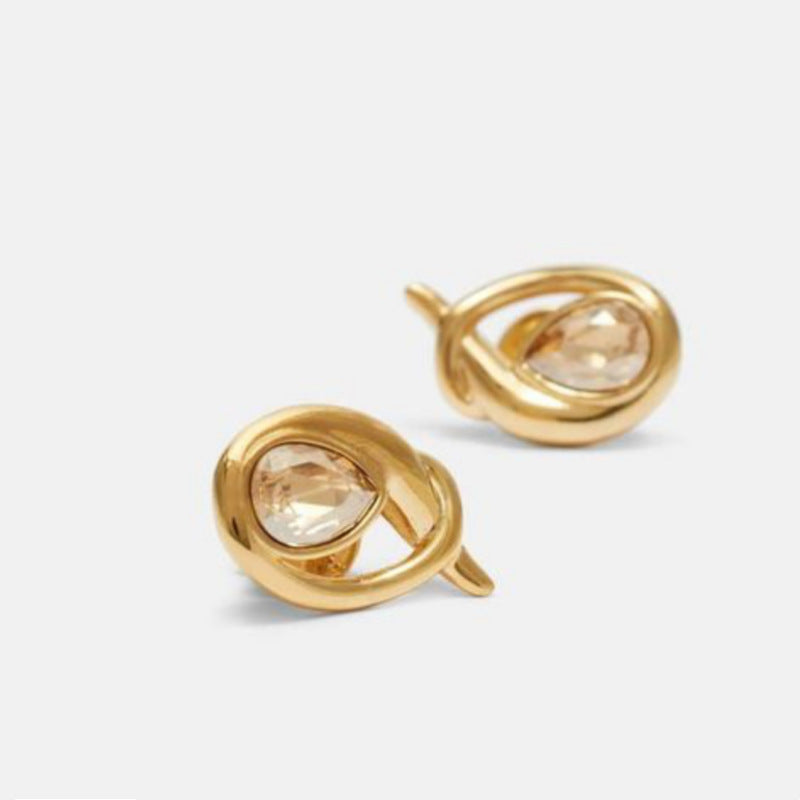 Gold-tone teardrop loop earrings with champagne center stones in angled view