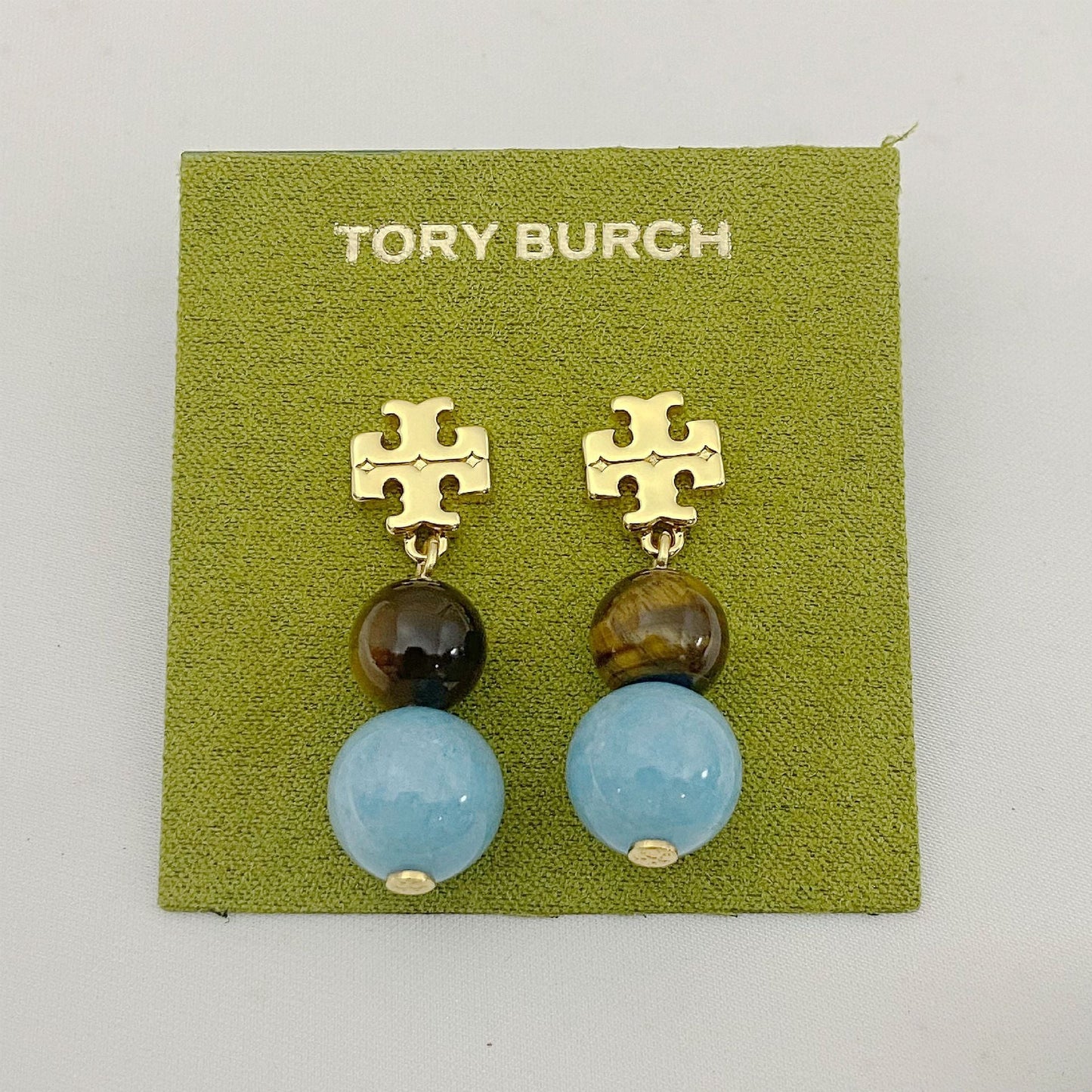 Tory Burch logo pendant earrings with dark bead and light blue agate beads