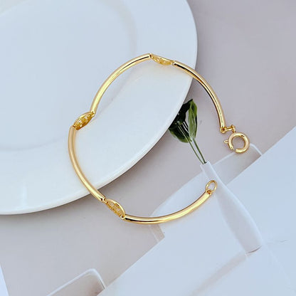 Gold-tone metal bangle with round logo link accents and hinge clasp
