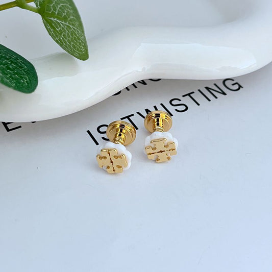 Gold-tone logo stud earrings with white enamel clover-like cutout and posts