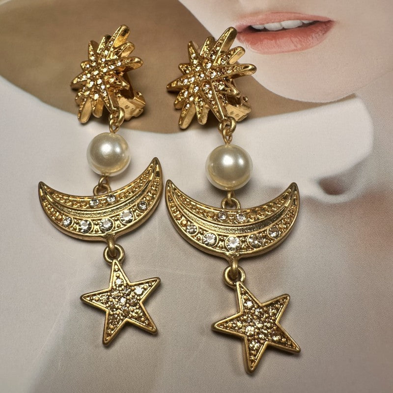 Gold star and moon drop earrings with pearl beads and crystal pavé details