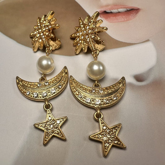 Gold star and moon drop earrings with pearl beads and crystal pavé details