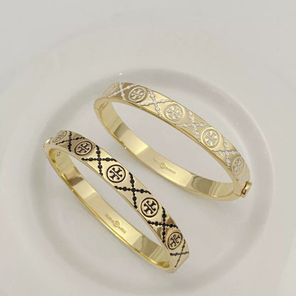Pair of Tory Burch enamel logo open cuff bangles, gold-tone with black and light enamel
