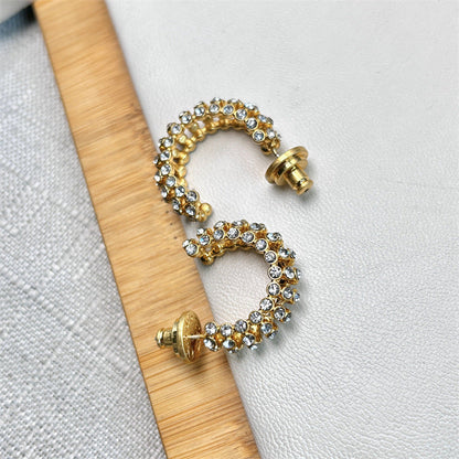 Gold-tone hoop earrings with clear cubic zirconia stones and gold posts