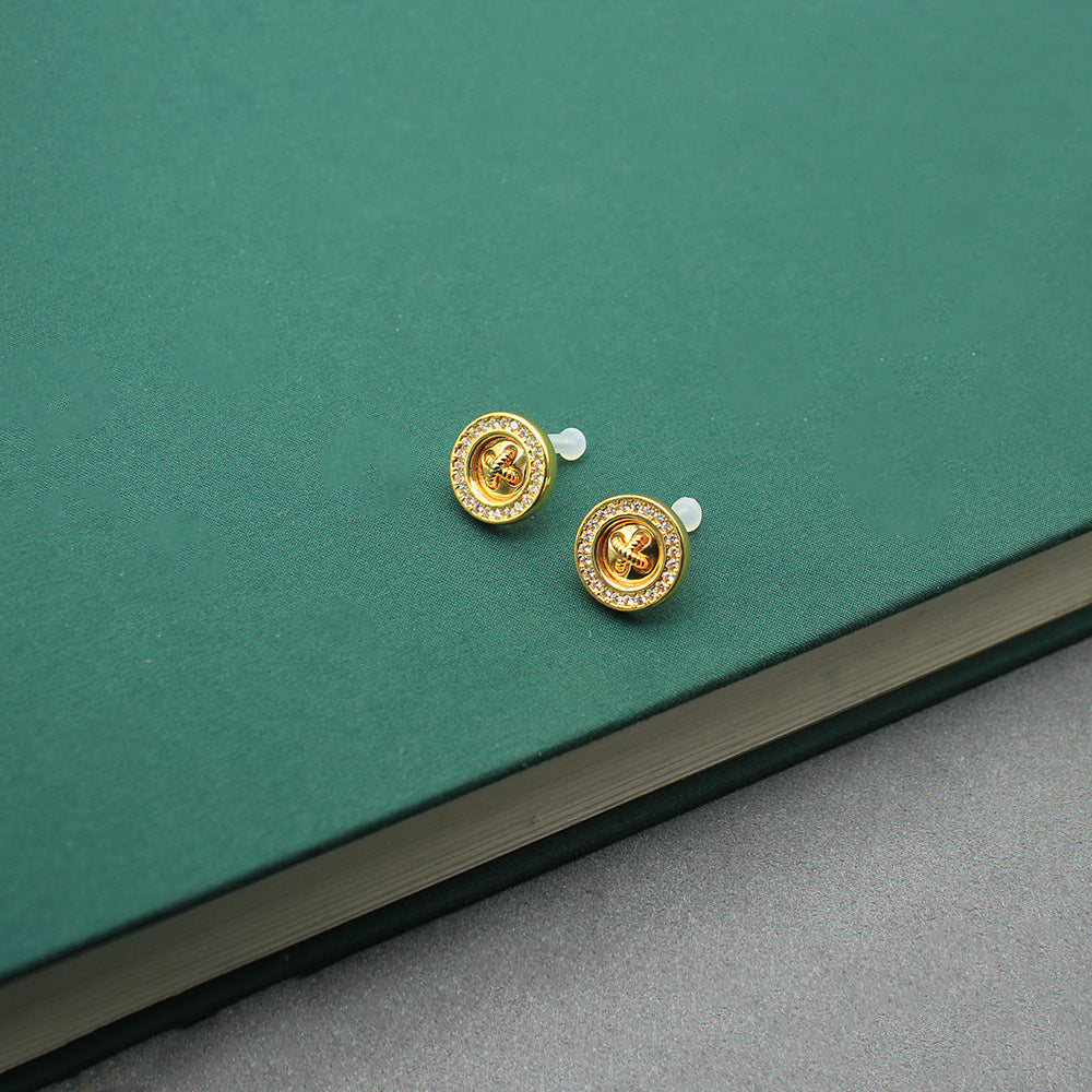 Gold-tone round coin clover stud earrings with white crystal accents