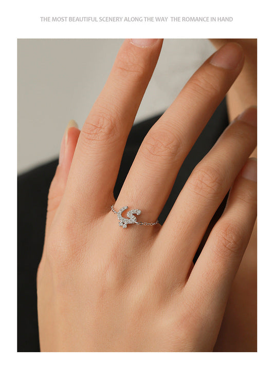 Arabic letter chain ring with pavé sparkle detail worn on finger