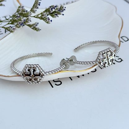 Tory Burch C-shaped hollow metal earrings for women