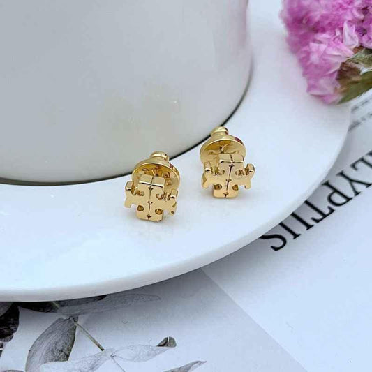 Gold-tone metal logo stud earrings with round backs and geometric emblem detail