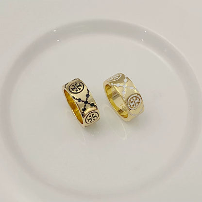 Round logo rings: one dark enamel, one white enamel, gold-tone band