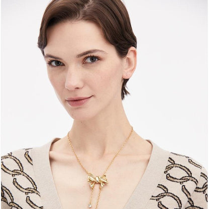 Bow crystal tassel necklace on neckline with dangling round stones