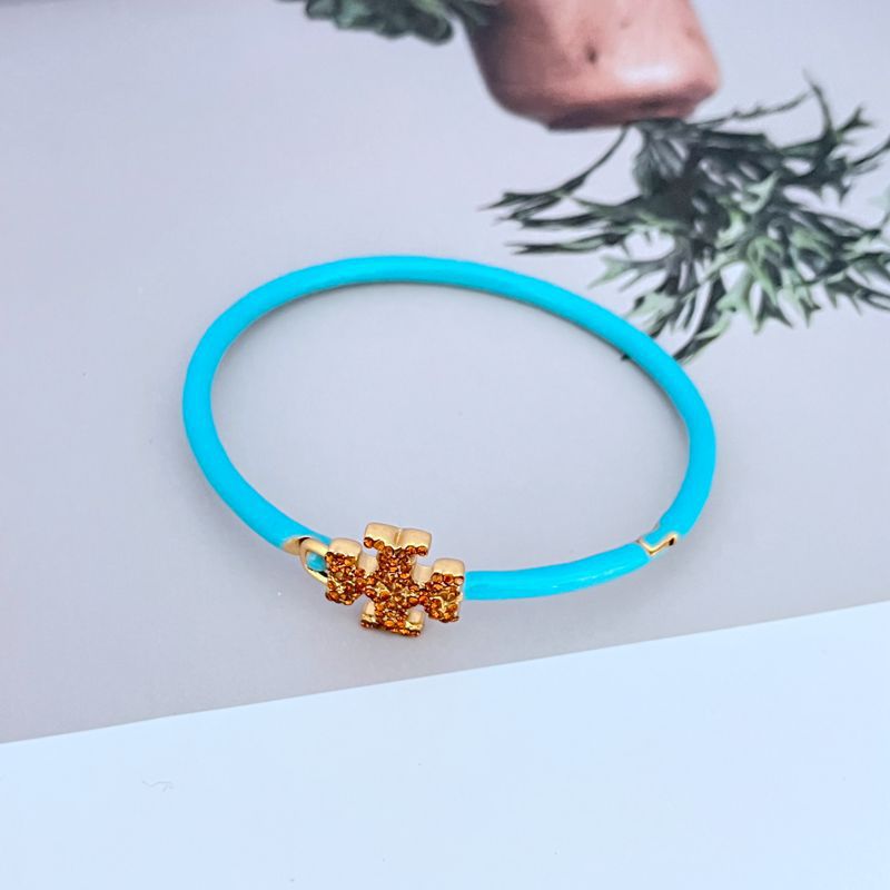 Blue openable bangle with enameled diamond cross charm centerpiece
