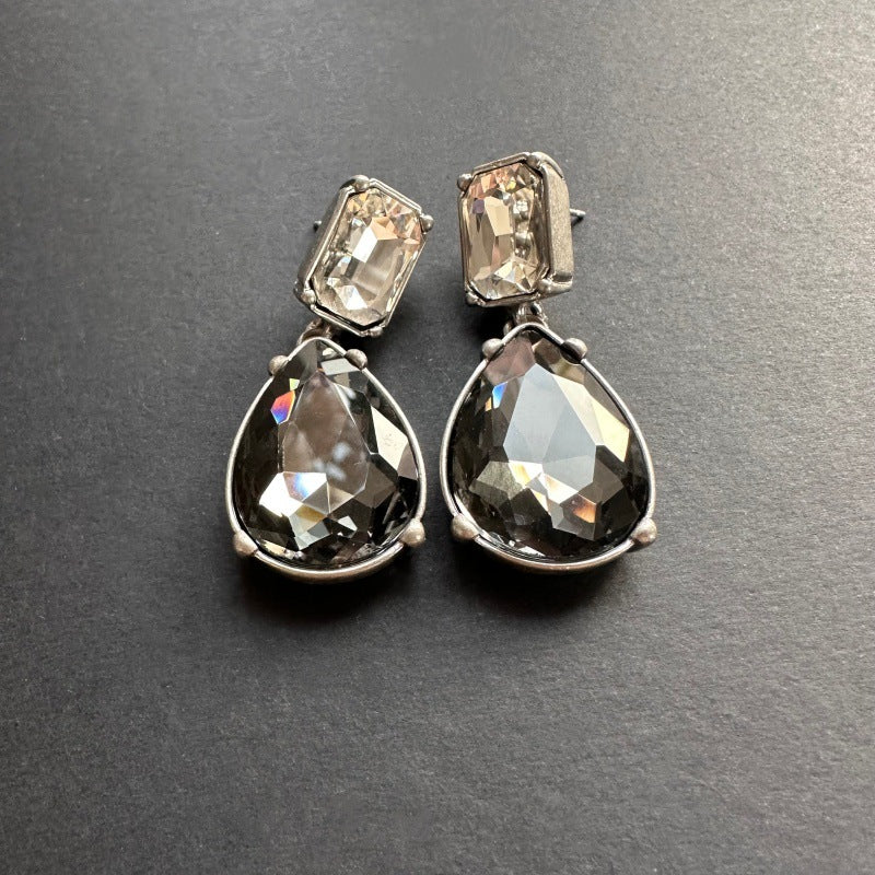 Teardrop-cut diamond stud earrings with clear smoky square tops and black teardrop stones