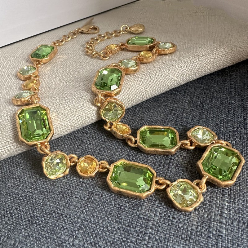 Square crystal pendant necklace with green faceted square crystals and gold-toned chain