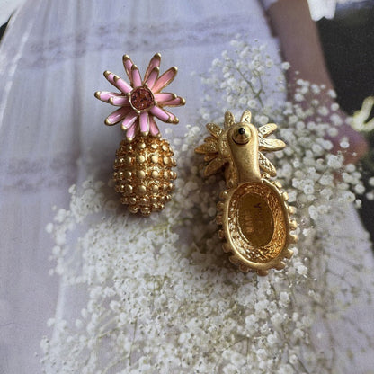 Enamel flower and pineapple diamond earrings with pink flower tops and gold textured drops.