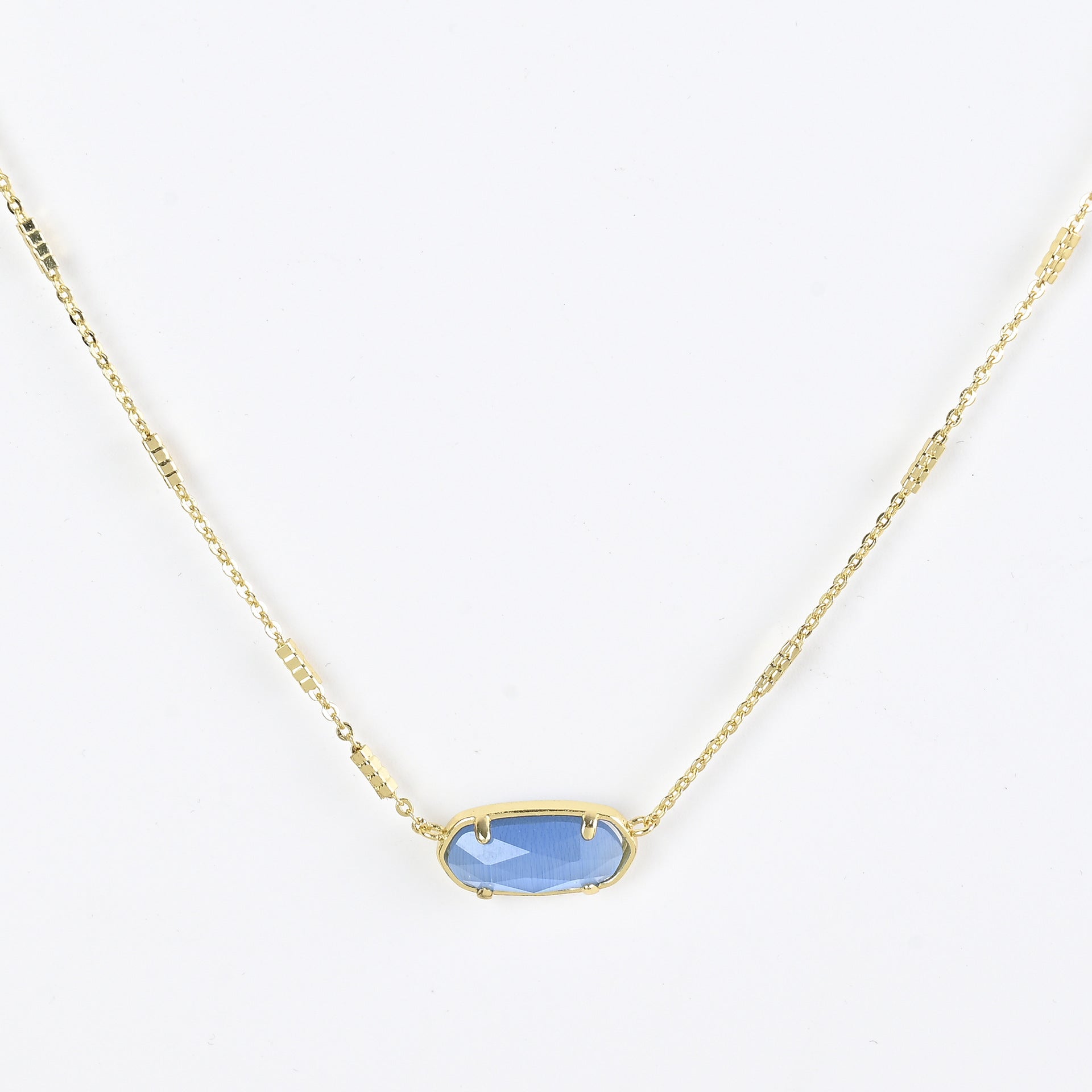 Oval crystal pendant necklace with light blue stone and gold bezel on a gold chain