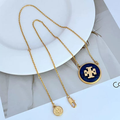 Gold-tone circle coin pendant necklace with blue round enamel charm and long chain