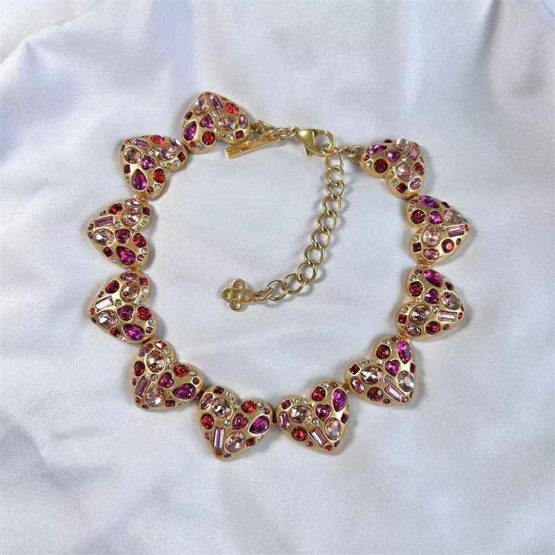 Vintage heart-shaped crystal necklace with gold chain and pink/purple rhinestone hearts
