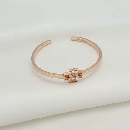 Openwork square logo smooth metal bangle, rose gold tone with central emblem detail