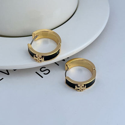 Gold-tone round hoop earrings with black enamel band and decorative front detail