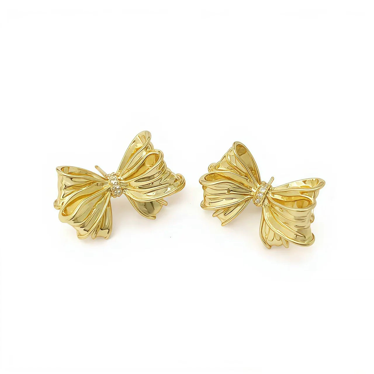 Gold-tone bow stud earrings with small crystal center, no visible pearl drops