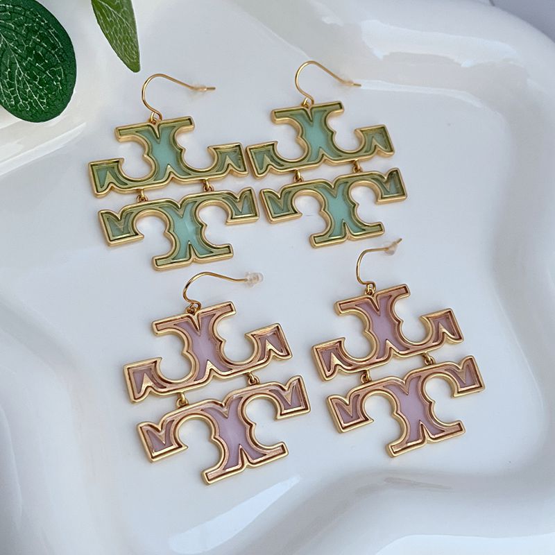 Acrylic logo drop earrings with gold-tone hooks and mint-green cutout letters