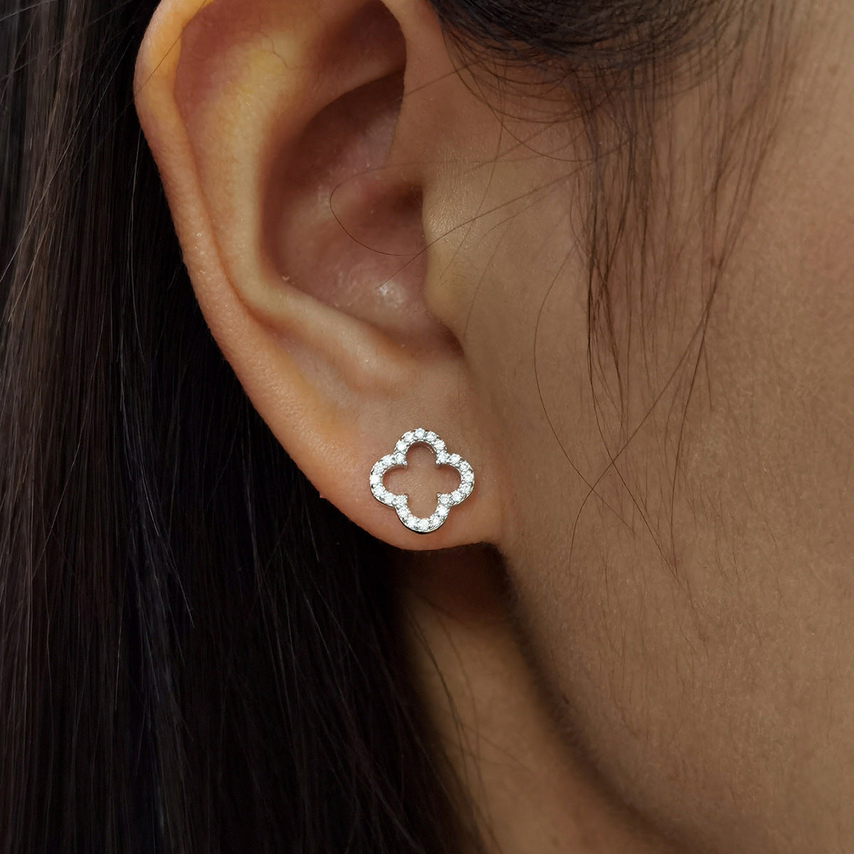 Silver-tone four-leaf clover stud earrings with openwork center and pavé stones
