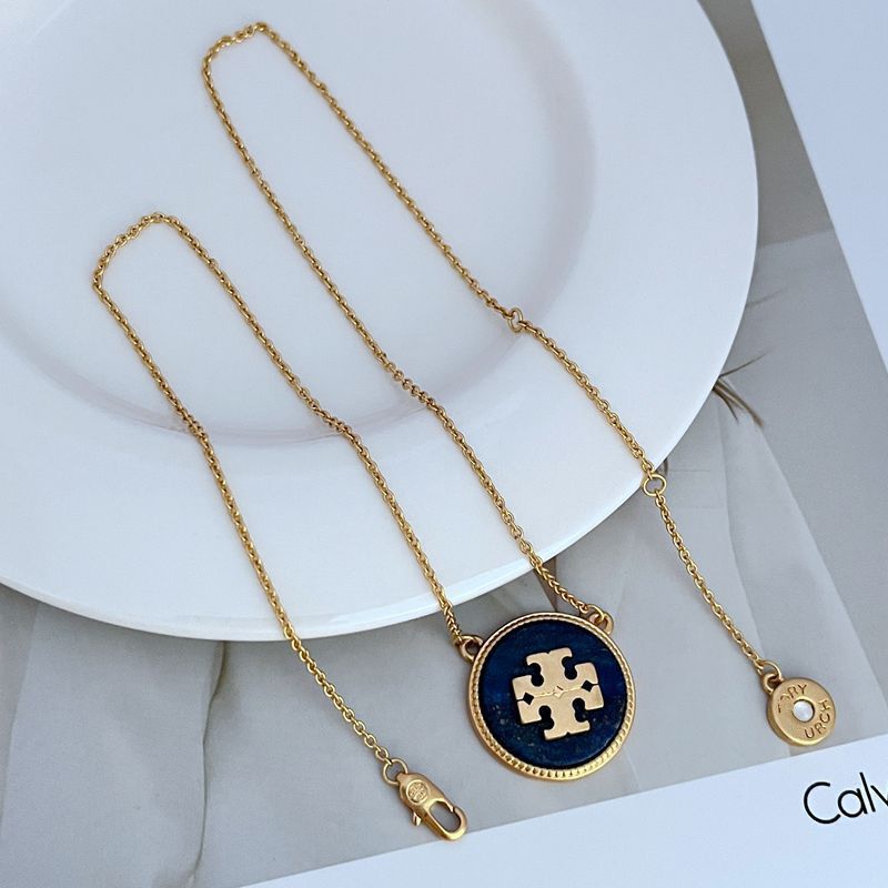 Gold-tone circle coin pendant necklace with purple and light coin charms on chain