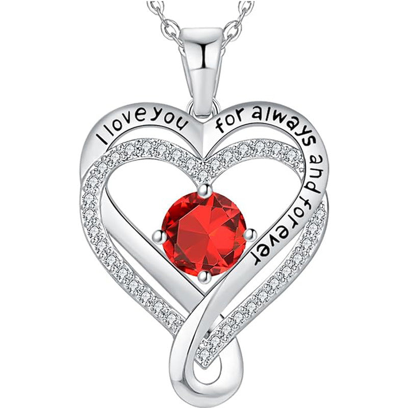 Silver heart pendant necklace with red round gemstone and raised heart border