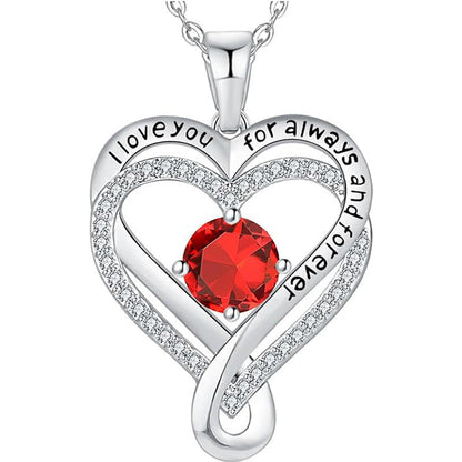 Silver heart pendant necklace with red round gemstone and raised heart border