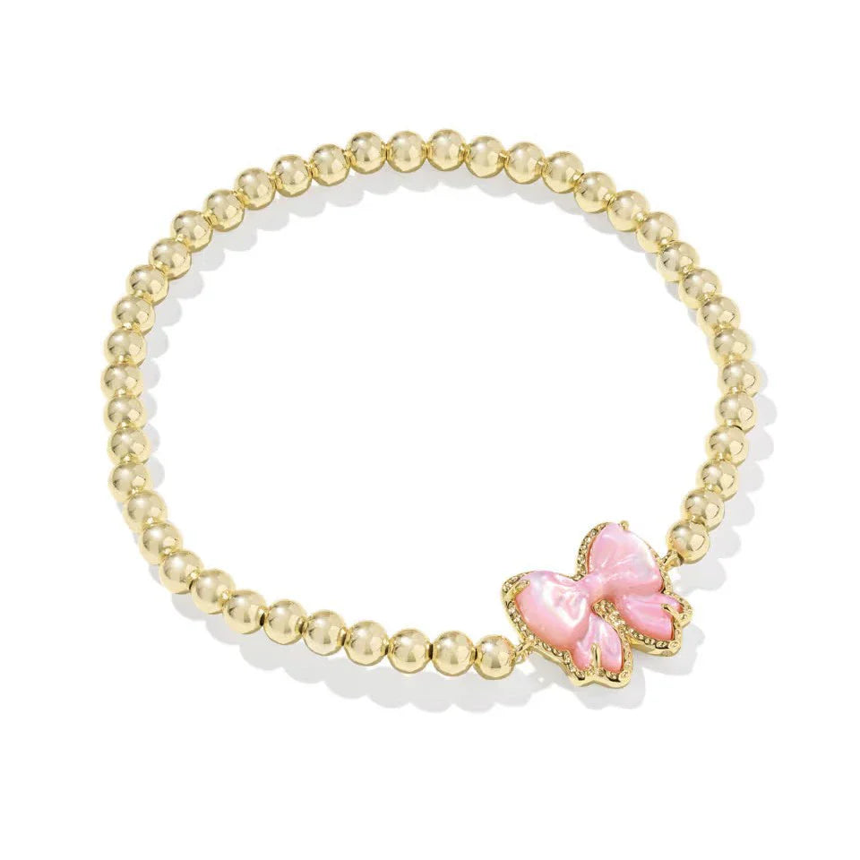 Gold-tone bead bracelet with pink bow charm centerpiece and clear-stone edging