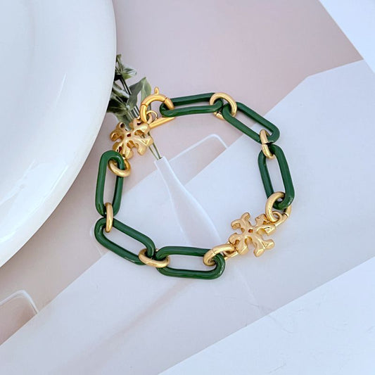 Green chunky chain bracelet with gold logo charms and thick linked metal clasp
