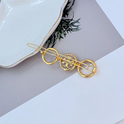 Tory Burch Diamond-Studded Round Metal Hair Clip