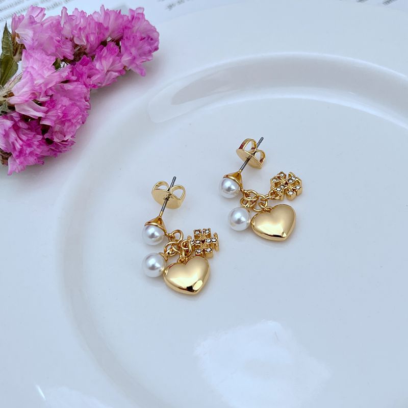 Gold-tone heart charm earrings with rhinestone accents and white pearls on hook posts