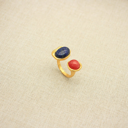 Adjustable open band gemstone ring with oval blue stone and red oval accent