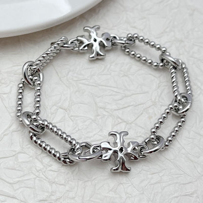 Silver square chunky chain logo bracelet with cross-like emblem charm and twisted chain links