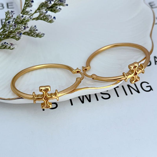 Gold-tone Tory Burch logo hoop earrings with small charm detail