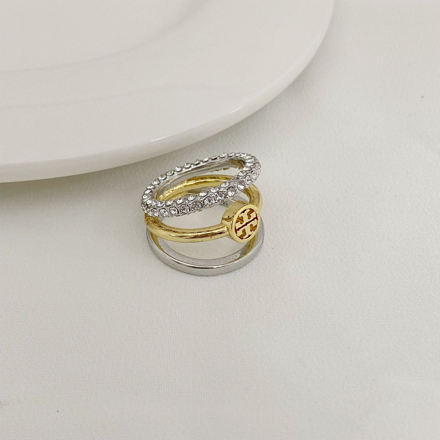 Rhinestone-trimmed three-band ring with gold center band and silver outer bands