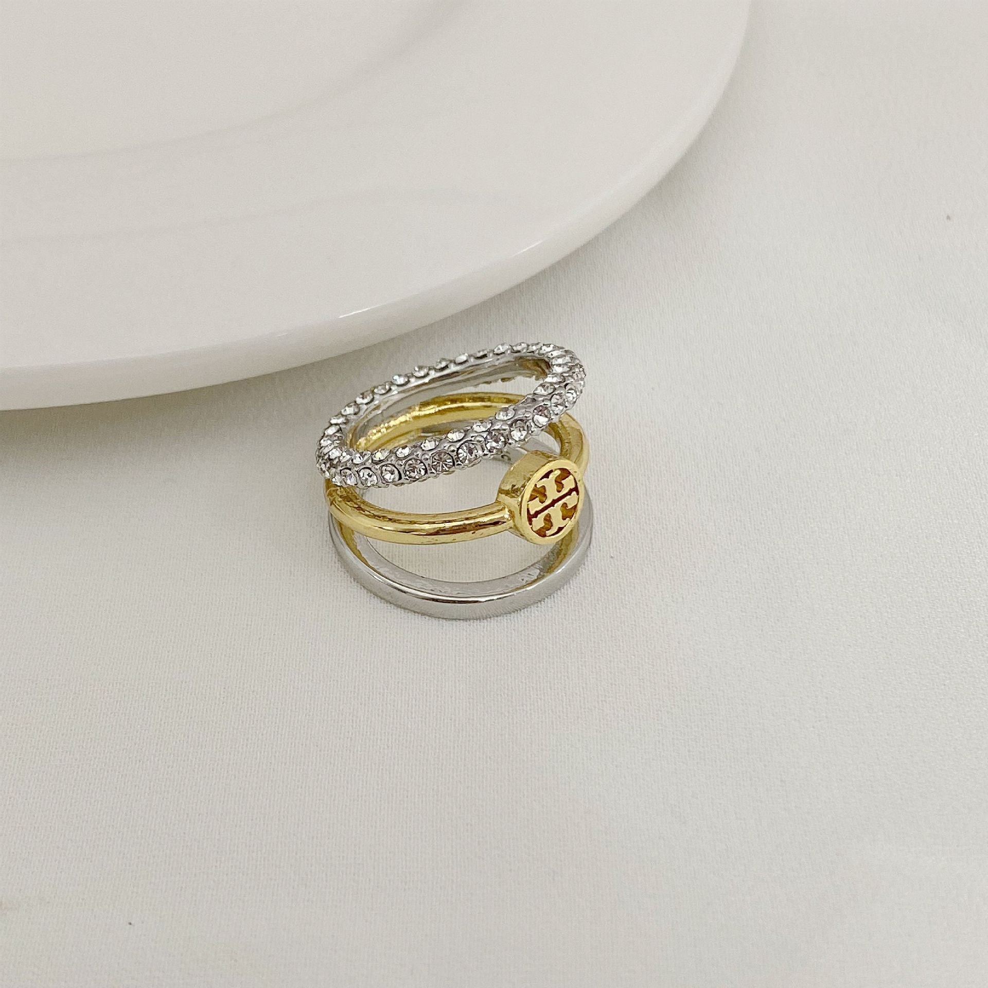 Rhinestone-trimmed three-band ring with gold center band and silver outer bands