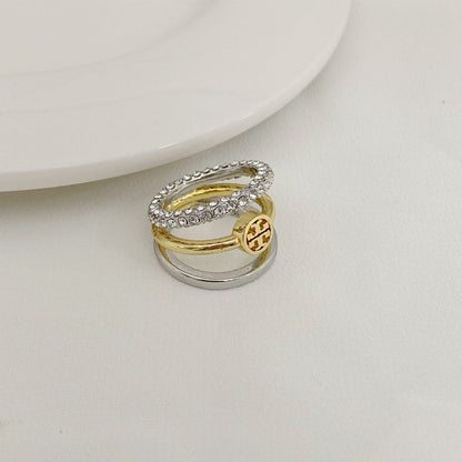 Rhinestone-trimmed three-band ring with gold center band and silver outer bands