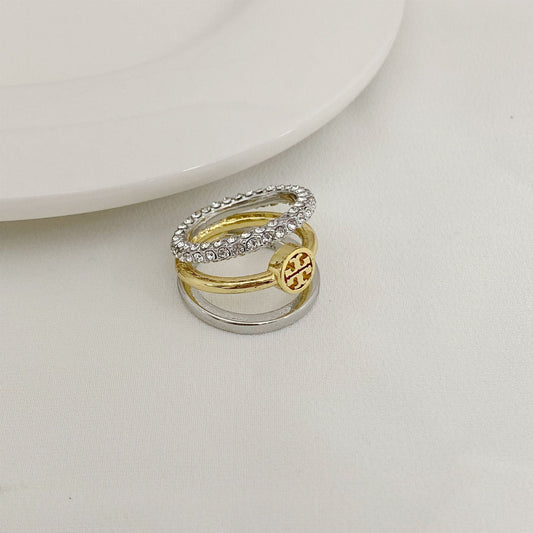 Rhinestone-trimmed three-band ring with gold center band and silver outer bands