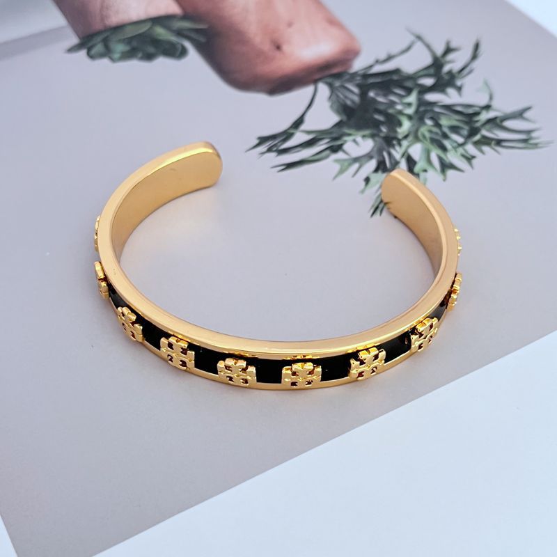 Enamel logo open metal bangle, black enamel band with gold-tone logo trim