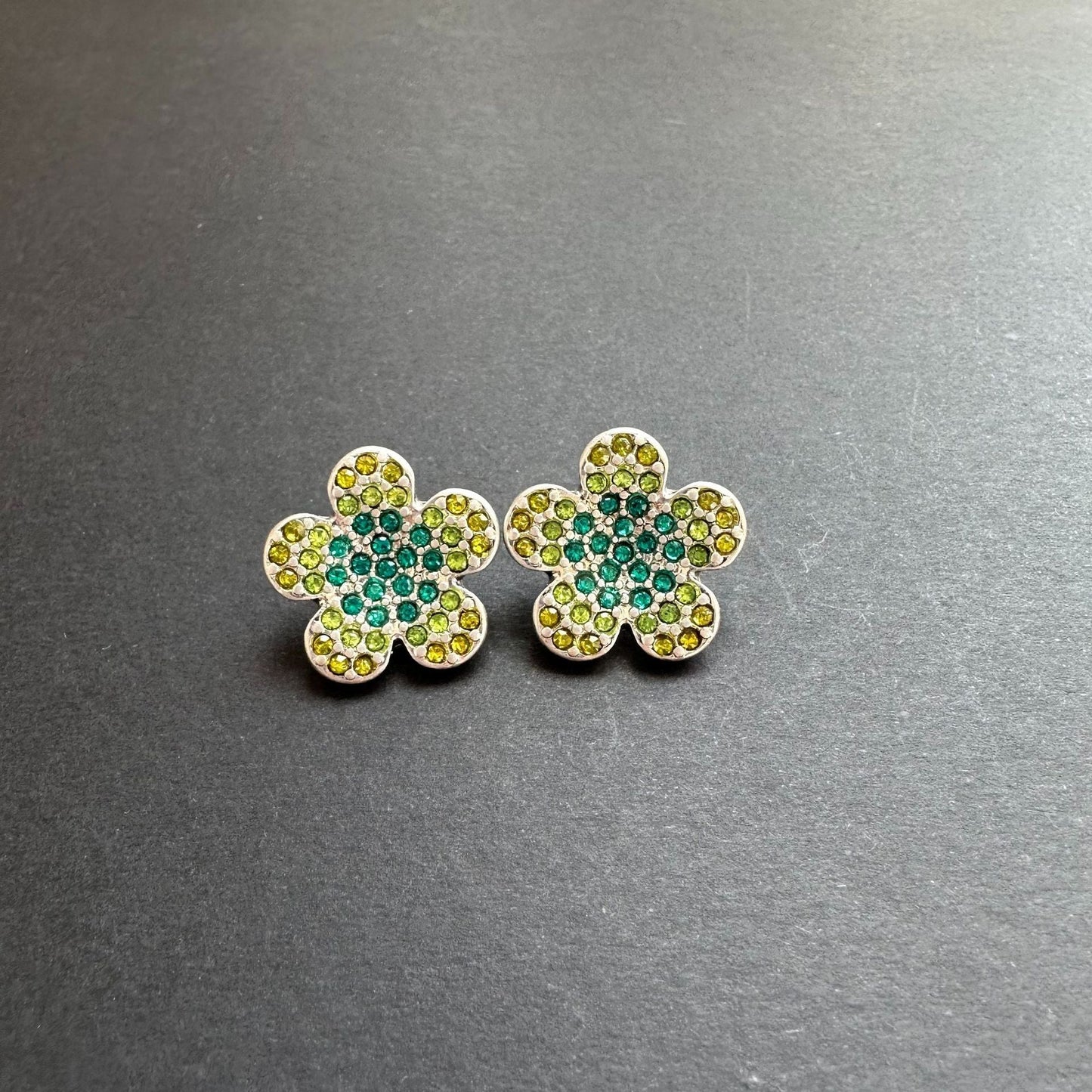 Gold-tone floral stud earrings with green and teal rhinestones